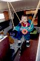 Alex's in his swing hanging in the companionway - Click for Enlarged Image